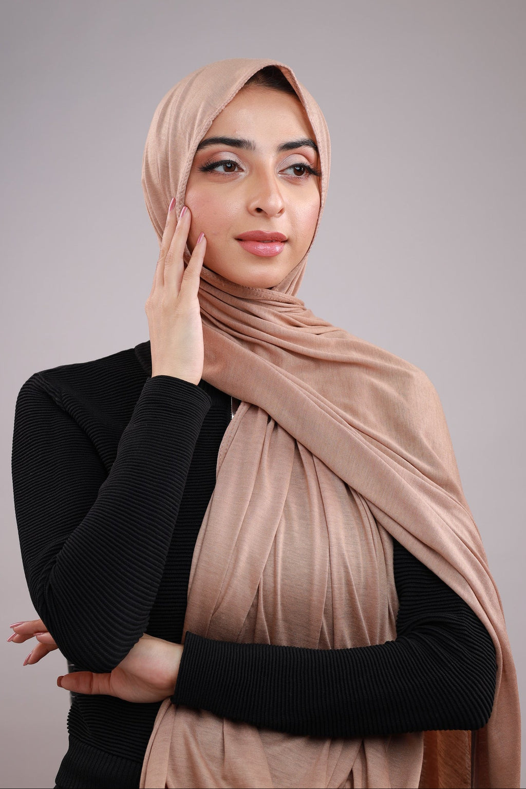 Model wearing a Cotton Jersey Hijab in Beige color made with non-slippery fabric, Hijab for sale in Pakistan.