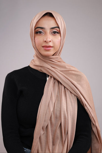 Model wearing a Beige Cotton Jersey Hijab in soft, non-slippery fabric. Full-coverage hijab for sale in Pakistan.