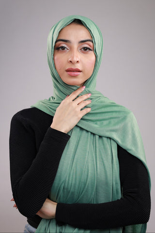 Model wearing a Matcha Green Cotton Jersey Hijab in soft, non-slippery fabric. Full-coverage hijab for sale in Pakistan.