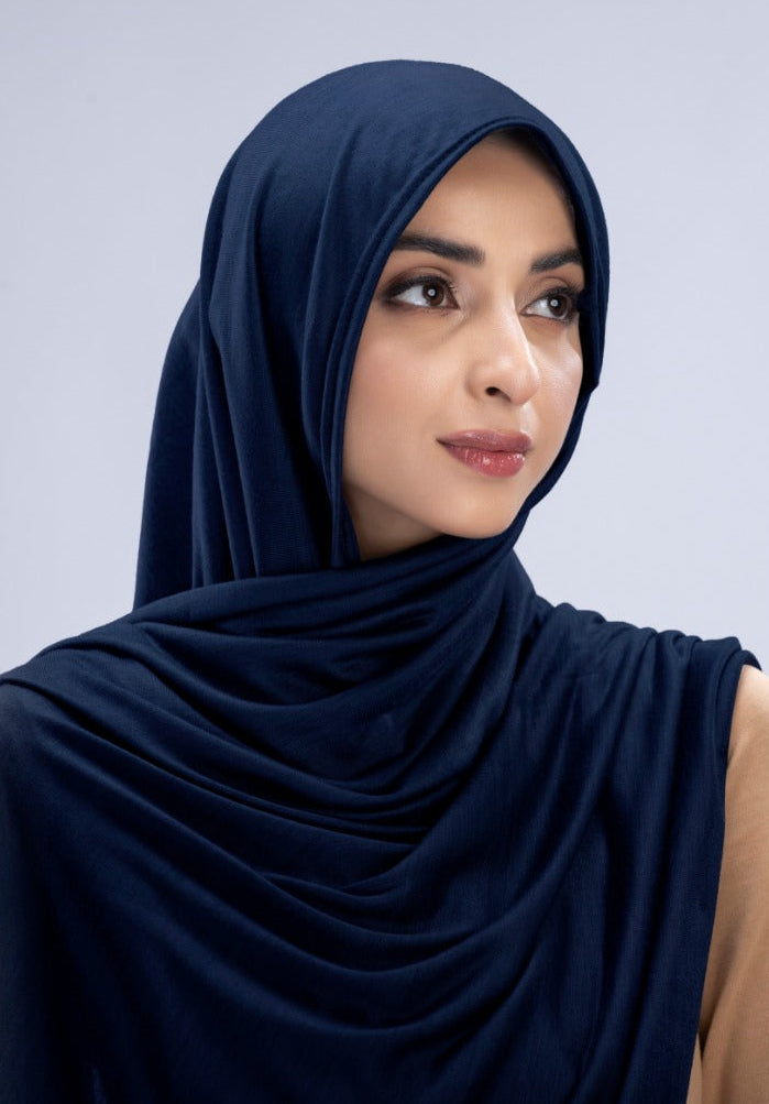 Model wearing a Navy Blue Cotton Jersey Hijab in soft, non-slippery fabric. Full-coverage hijab for sale in Pakistan.