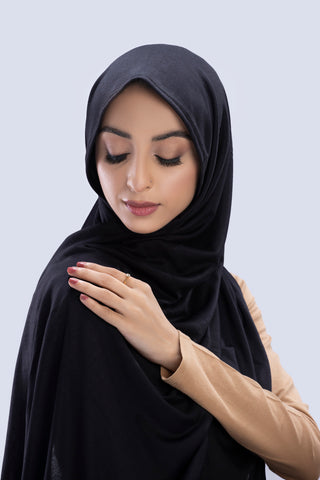 Model wearing a Black Cotton Jersey Hijab in soft, non-slippery fabric. Full-coverage hijab for sale in Pakistan.