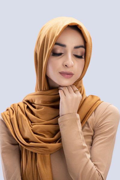 Model wearing a Cotton Jersey Hijab in Almond color made with non-slippery fabric, Hijab for sale in Pakistan.