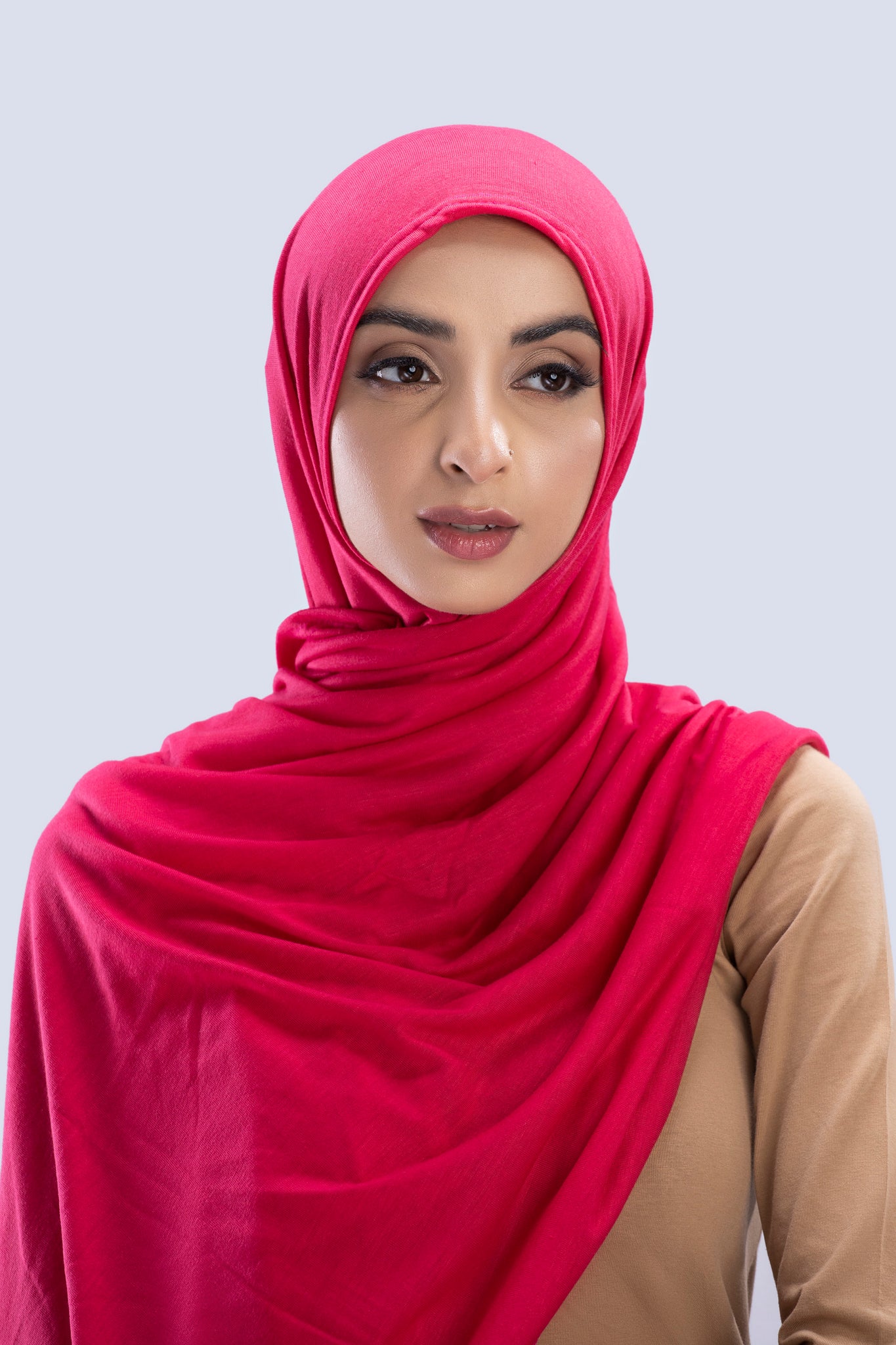 Model wearing a Fuchsia Cotton Jersey Hijab in soft, non-slippery fabric. Full-coverage hijab for sale in Pakistan.
