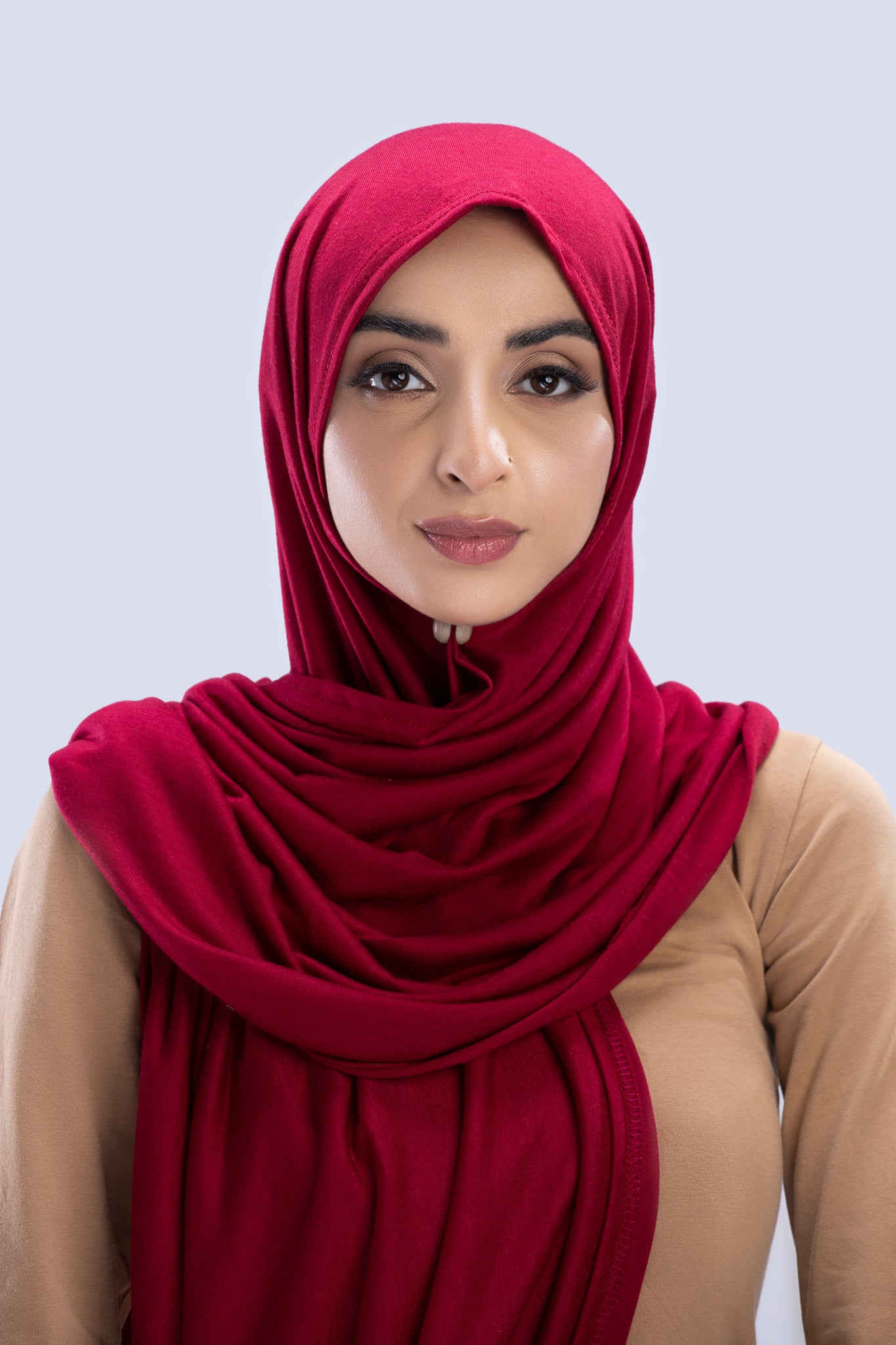 Model wearing a Maroon Cotton Jersey Hijab in soft, non-slippery fabric. Full-coverage hijab for sale in Pakistan.