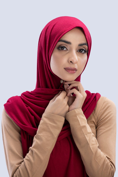 Model wearing a Cotton Jersey Hijab in Maroon color made with non-slippery fabric, Hijab for sale in Pakistan.