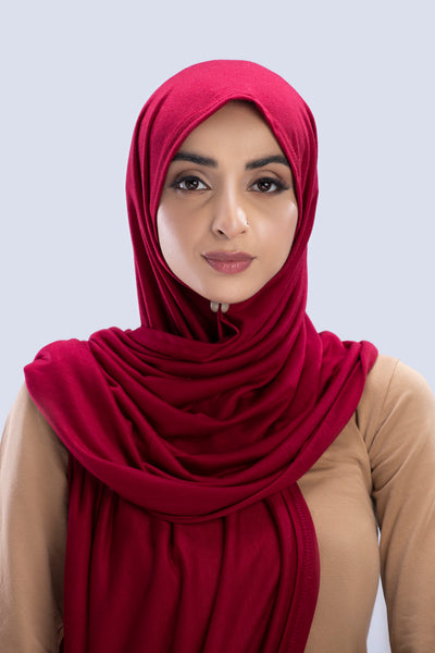 Model wearing a Maroon Cotton Jersey Hijab in soft, non-slippery fabric. Full-coverage hijab for sale in Pakistan.