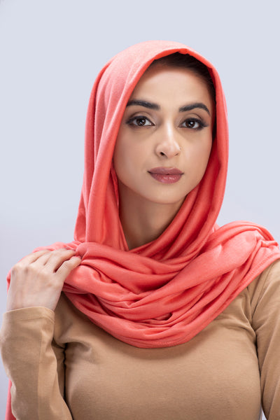 Model wearing a Cotton Jersey Hijab in Peach color made with non-slippery fabric, Hijab for sale in Pakistan.