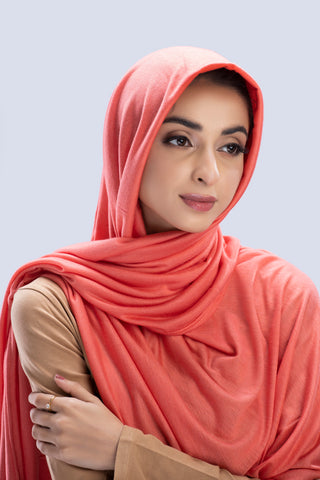 Model wearing a Peach Cotton Jersey Hijab in soft, non-slippery fabric. Full-coverage hijab for sale in Pakistan.