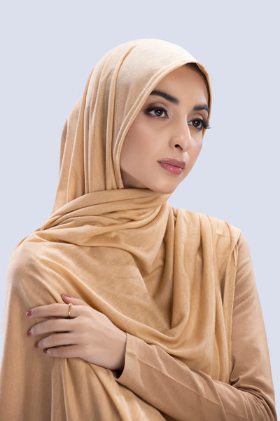 Model wearing a Cotton Jersey Hijab in Peanut color made with non-slippery fabric, Hijab for sale in Pakistan.