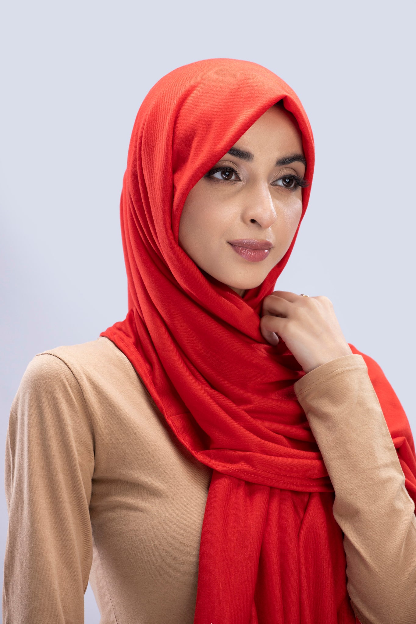 Model wearing a Scarlet Cotton Jersey Hijab in soft, non-slippery fabric. Full-coverage hijab for sale in Pakistan.
