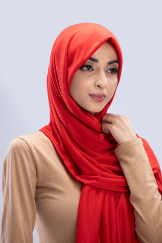 Model wearing a Scarlet Cotton Jersey Hijab in soft, non-slippery fabric. Full-coverage hijab for sale in Pakistan.